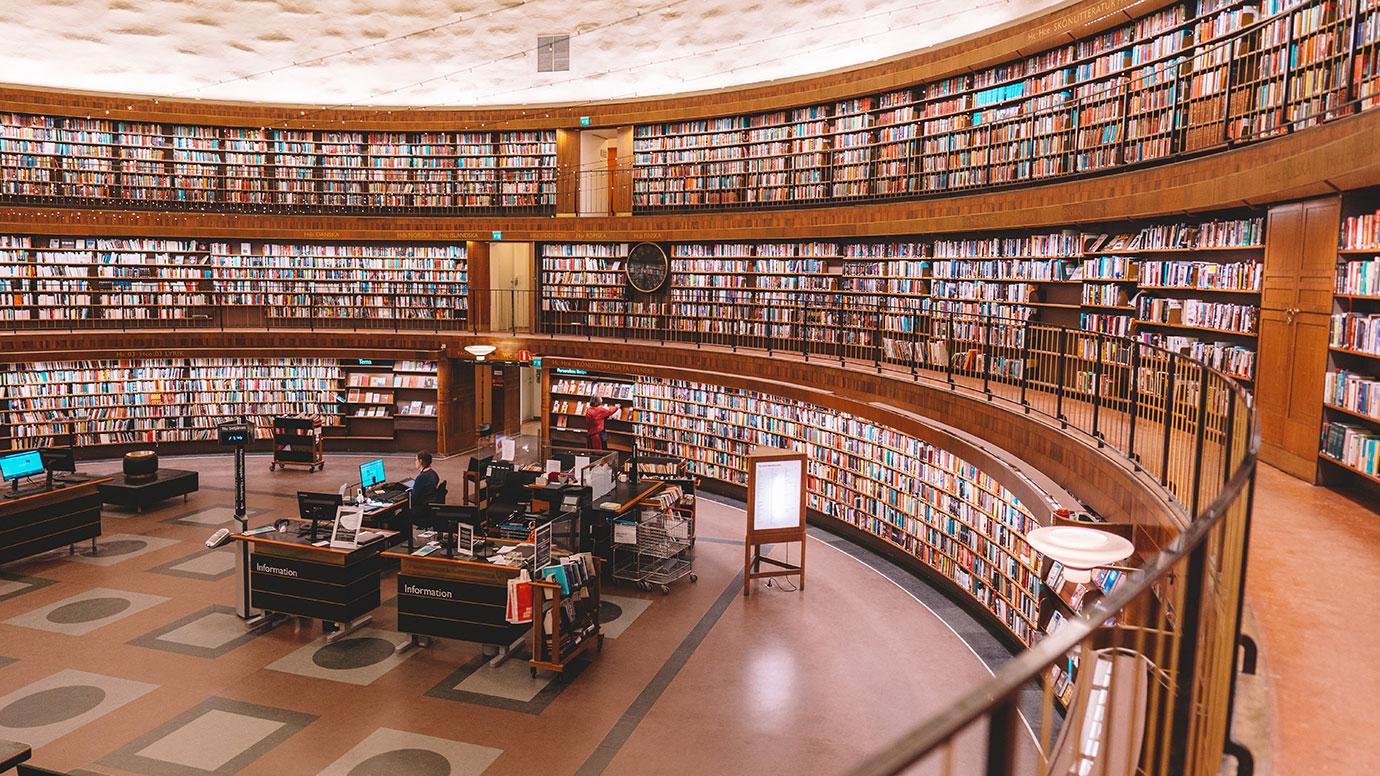 View of the main round hall of Stadsbibliotek, Stockholm's public library, with colorful books on shelfs