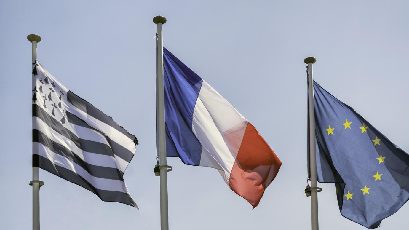 The flags of Brittany, France and the European Union.